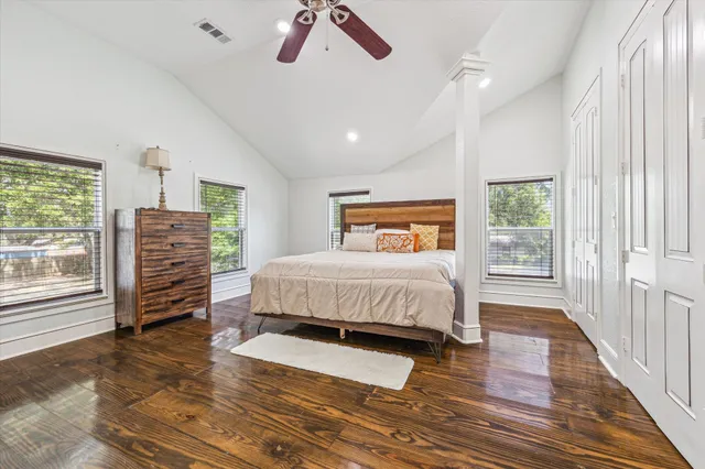 a bedroom with a bed and wooden floor