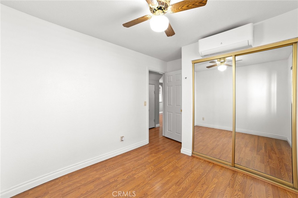 17800 Rancho Bonita Road Victorville, CA 92395 - Photo 19 of 52 an empty room with wooden floor fan and windows
