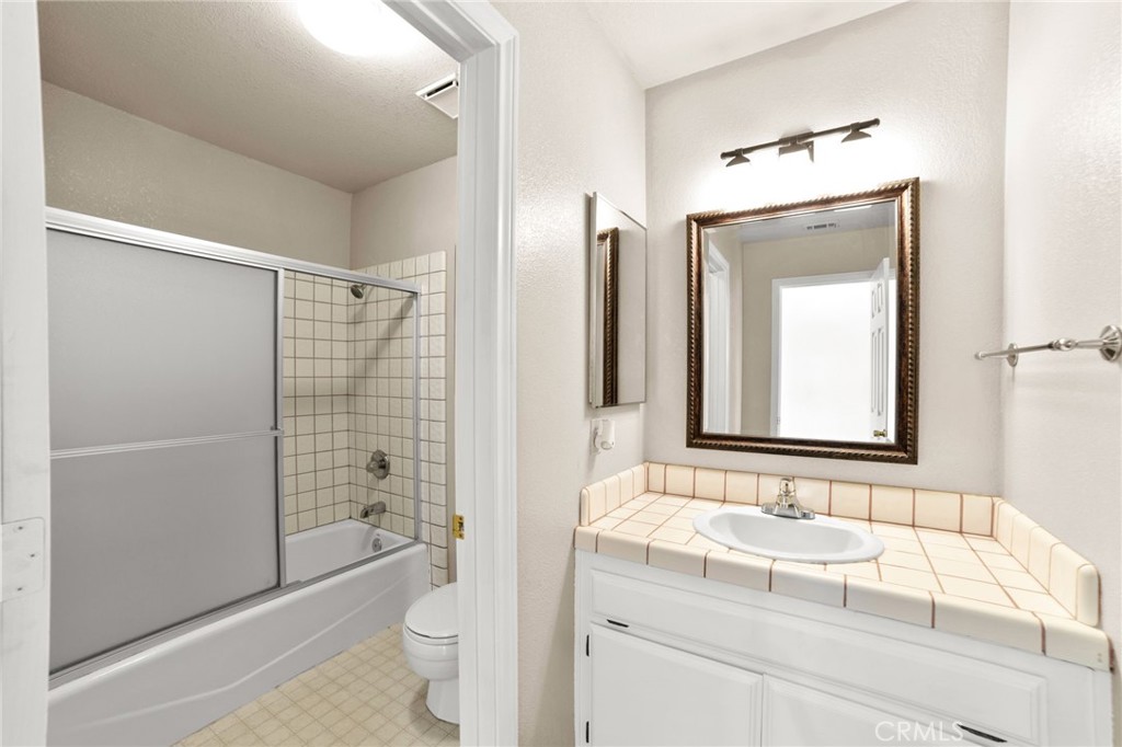 17800 Rancho Bonita Road Victorville, CA 92395 - Photo 23 of 52 a bathroom with a granite countertop sink toilet and shower