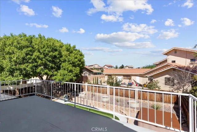an aerial view of a house with a yard and a large tree