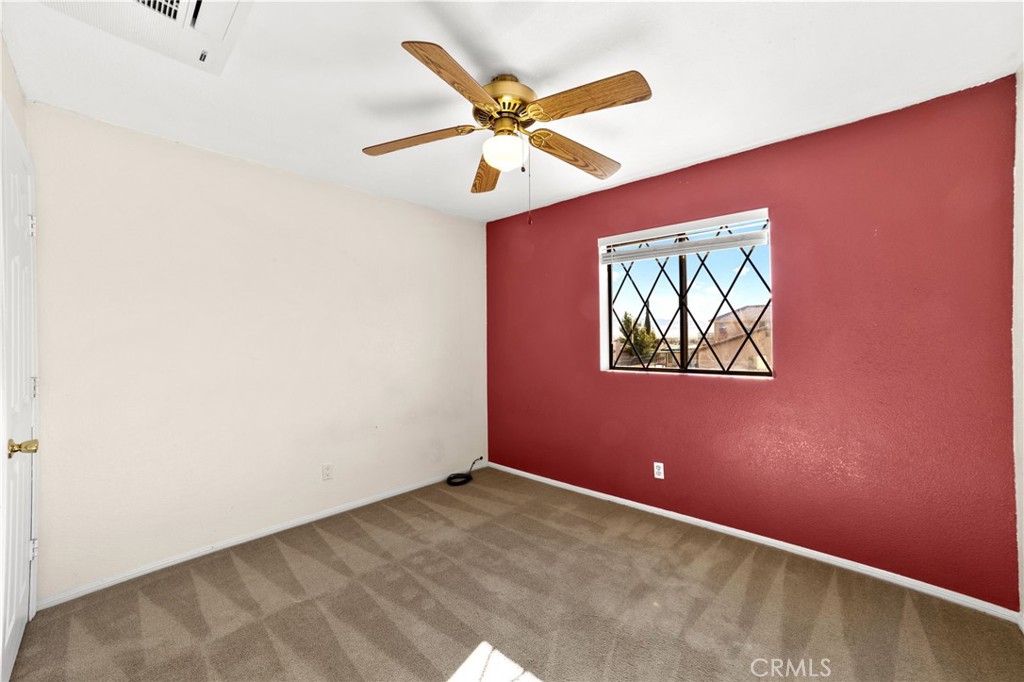 17800 Rancho Bonita Road Victorville, CA 92395 - Photo 28 of 52 an empty room with ceiling fan and window