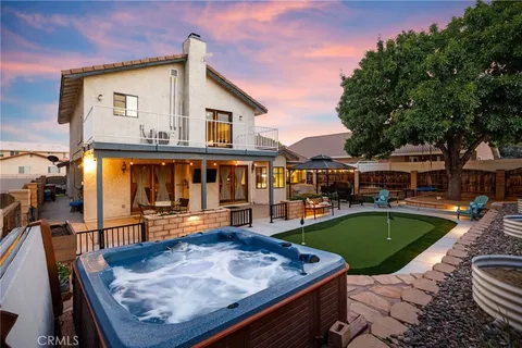 a view of a house with swimming pool and sitting area