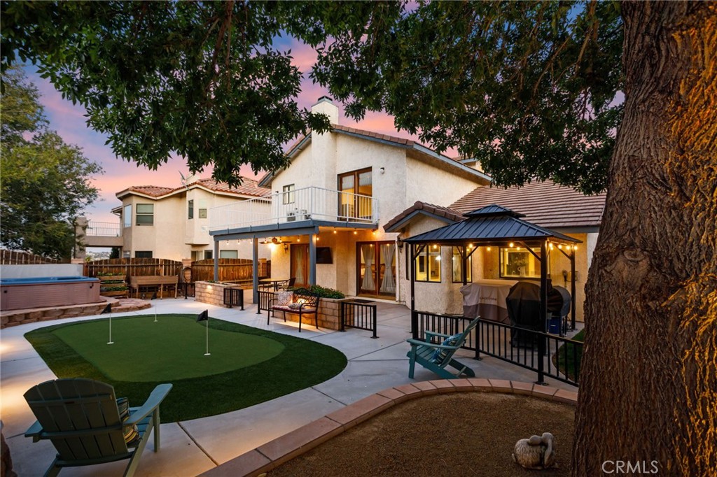17800 Rancho Bonita Road Victorville, CA 92395 - Photo 32 of 52 a view of a white house with a big yard and large trees