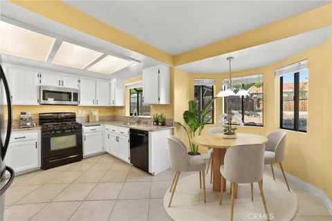a large kitchen with sink and cabinets