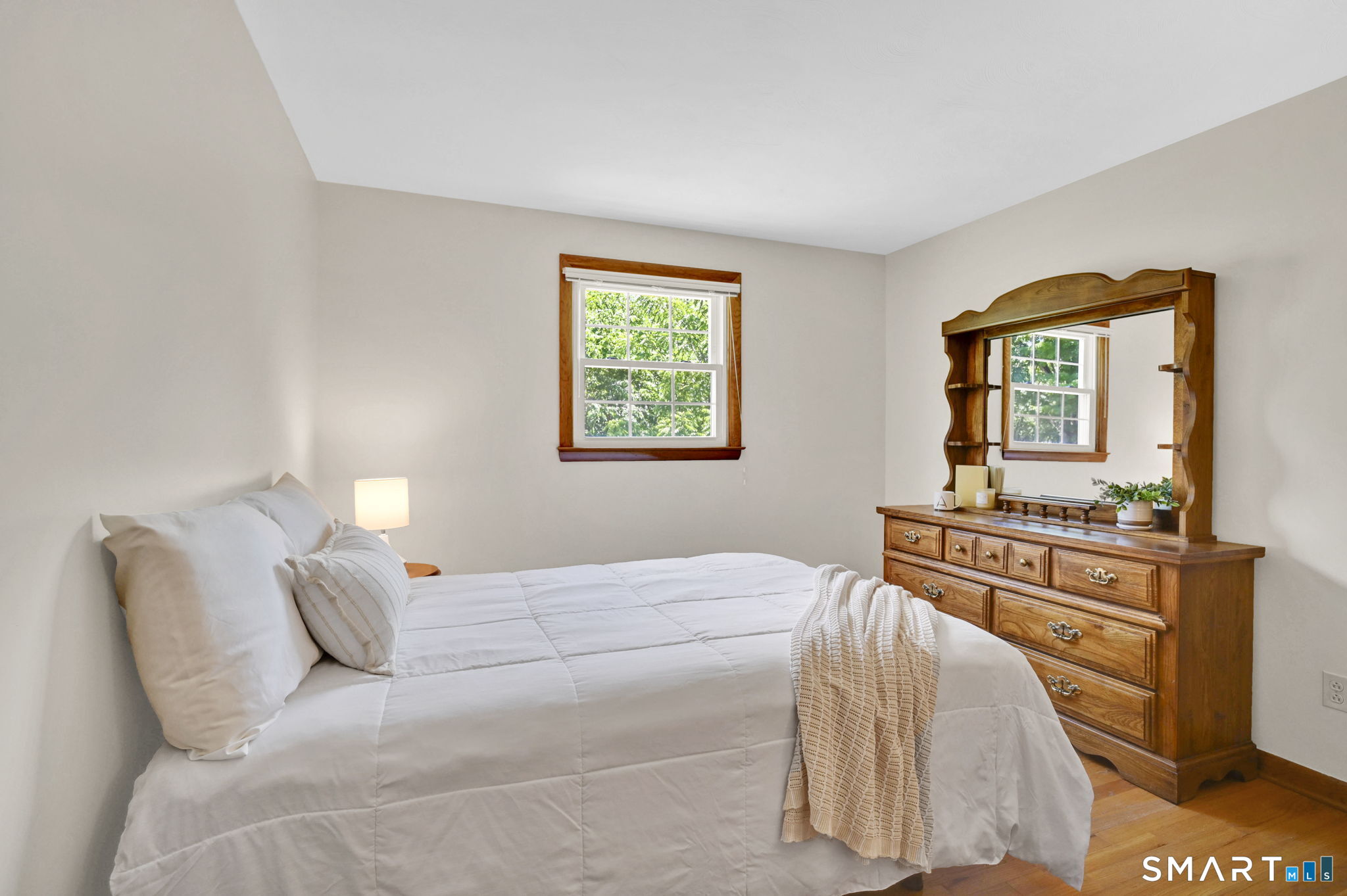 296 Phoenix Street Vernon, CT 06066 - Photo 15 of 34 a bedroom with a bed and dresser with mirror