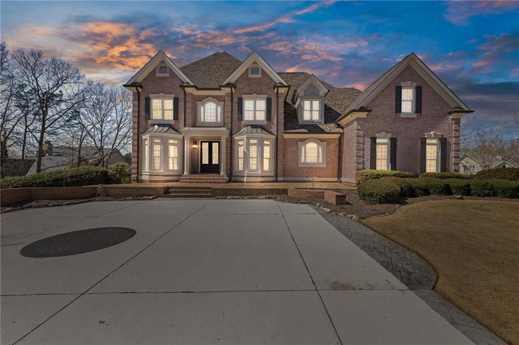 2010 Legends Way Braselton, GA 30517 - Photo 3 of 77 a front view of a house with yard and green space