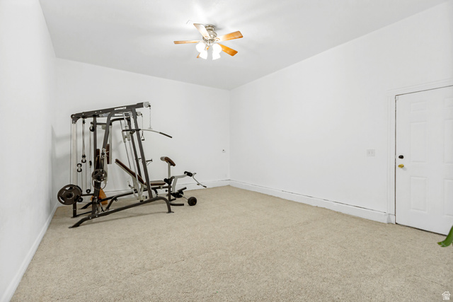 1585 South 910 West Payson, UT 84651 - Photo 12 of 32 Carpeted room with white walls, a ceiling fan with wood-finish blades, and a paneled white door
