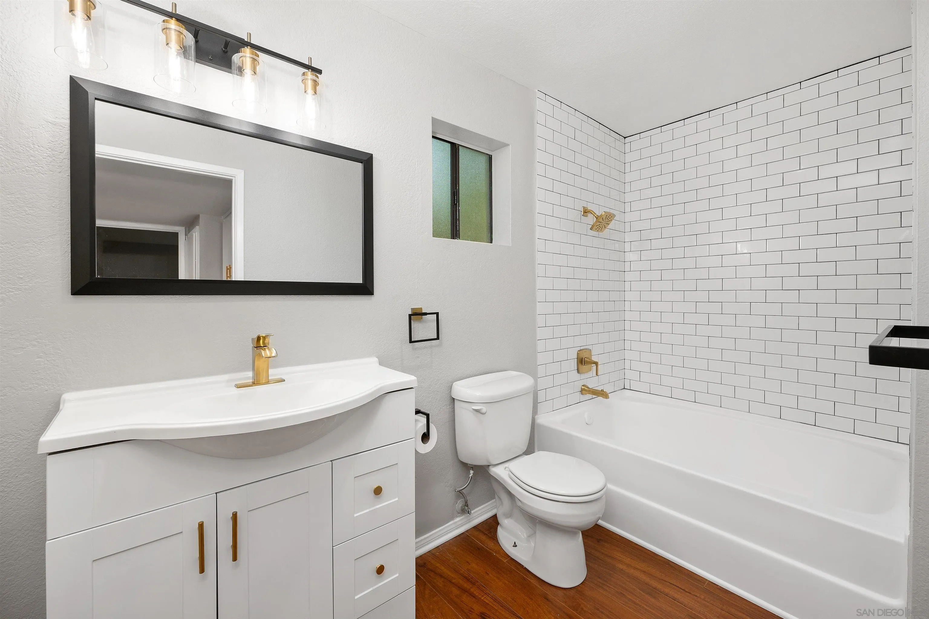 2157 Arnold Way, Unit 312 Alpine, CA 91901 - Photo 18 of 26 a bathroom with a toilet a sink a mirror and bathtub