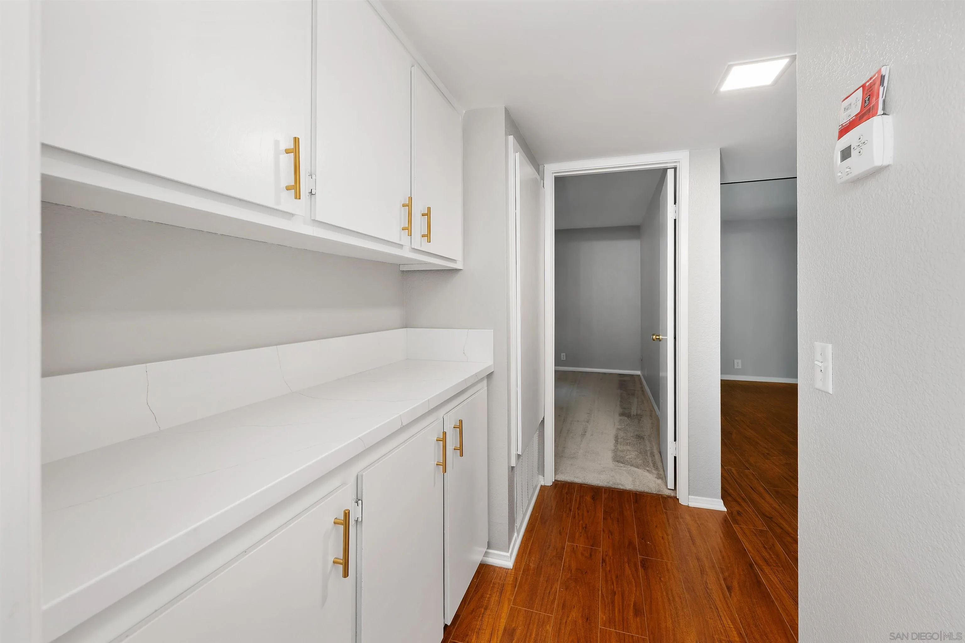 2157 Arnold Way, Unit 312 Alpine, CA 91901 - Photo 19 of 26 a kitchen with cabinets and wooden floor