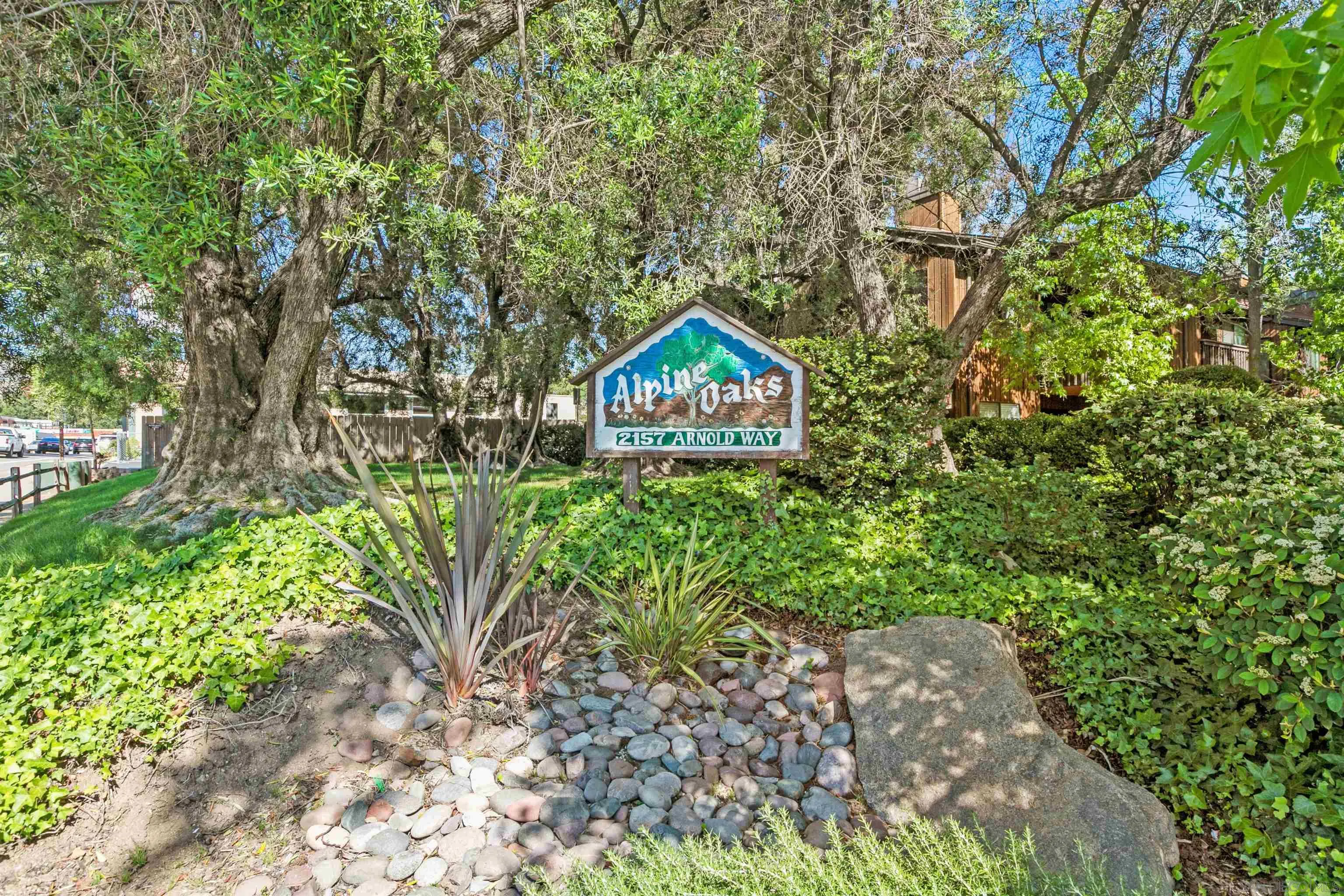 2157 Arnold Way, Unit 312 Alpine, CA 91901 - Photo 2 of 26 a garden with trees in front of it