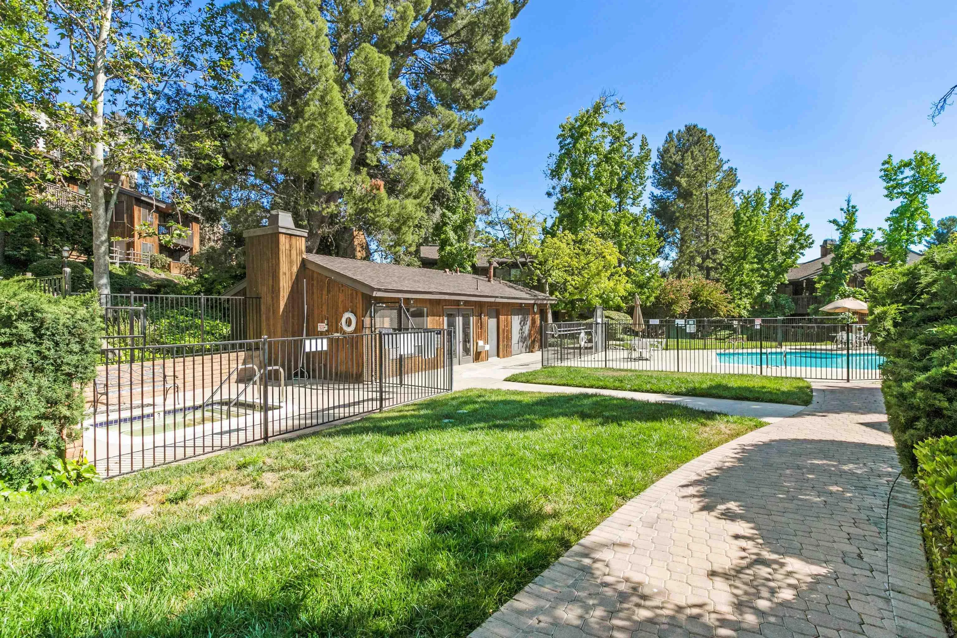 2157 Arnold Way, Unit 312 Alpine, CA 91901 - Photo 23 of 26 a view of a house with a yard and a garden