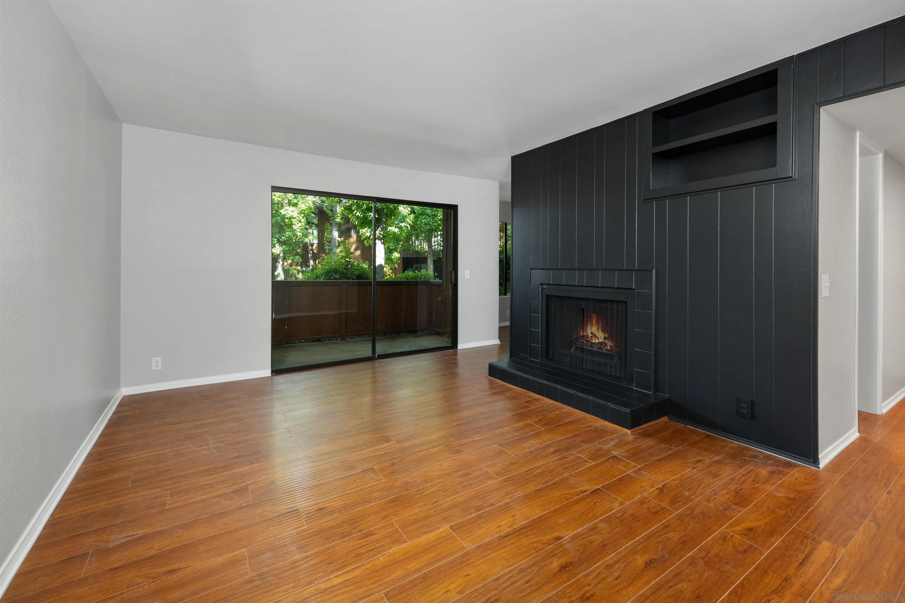 2157 Arnold Way, Unit 312 Alpine, CA 91901 - Photo 7 of 26 a view of empty room with wooden floor and fireplace
