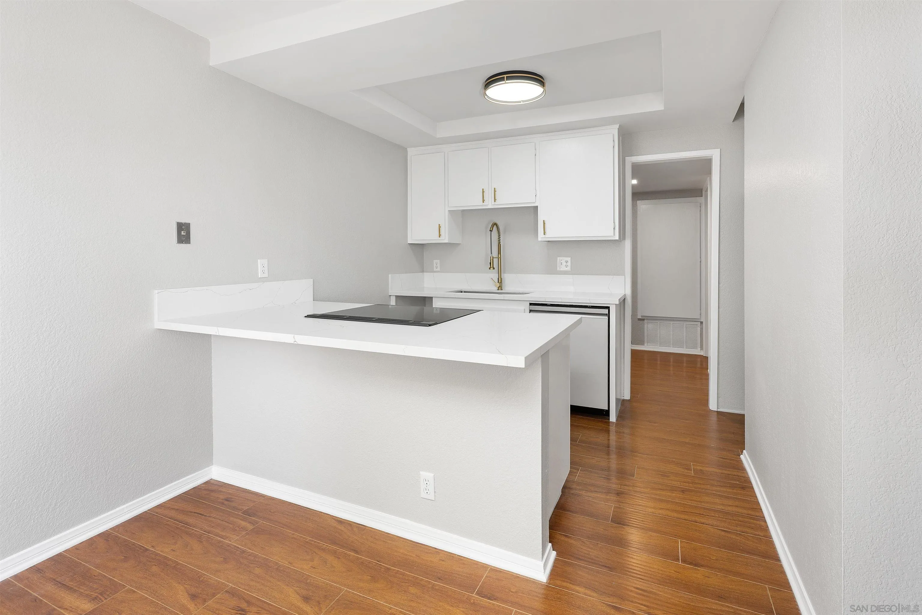 2157 Arnold Way, Unit 312 Alpine, CA 91901 - Photo 10 of 26 a kitchen with a sink cabinets and wooden floor