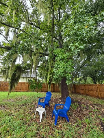 a backyard of a house with table and chairs