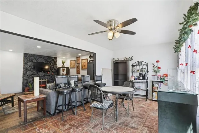 a view of a dining room with furniture and a potted plant