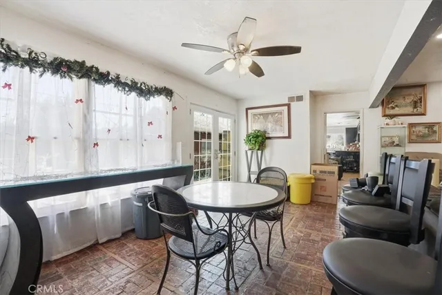 a living room with furniture a window and a dining table