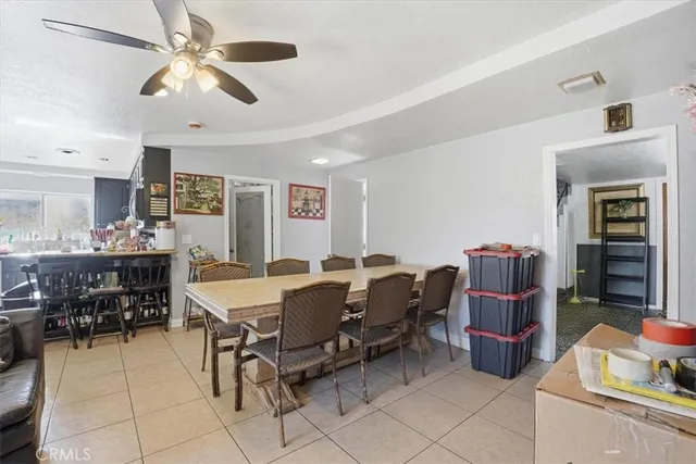 a living room with furniture a flat screen tv and a table