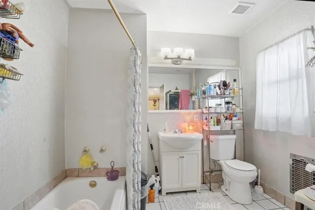 a bedroom with bed and a baby crib