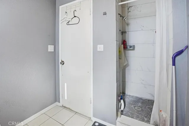 a bathroom with a sink and mirror with bathtub