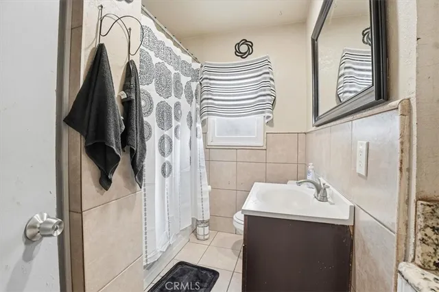 a bathroom with a sink and glass door shower