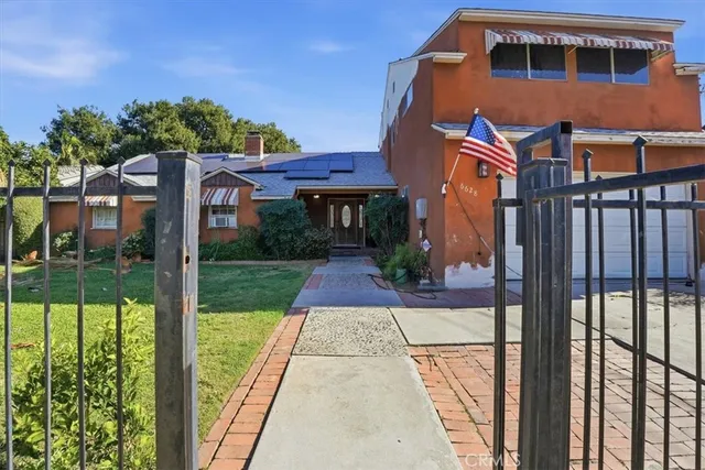 a front view of a house with garden