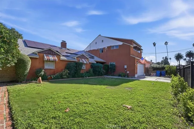a view of a patio with couches table and chairs and potted plants