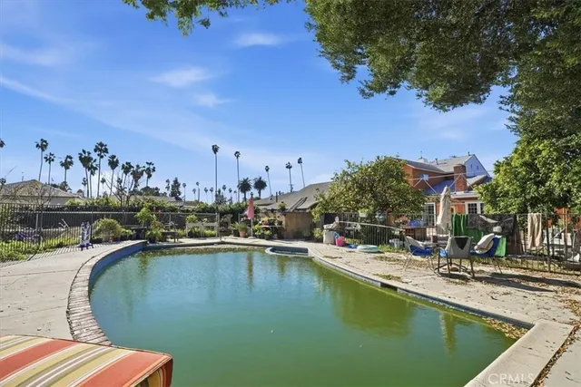 a view of a swimming pool with outdoor seating