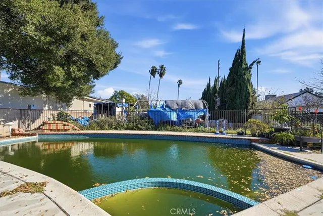 a view of a swimming pool with lounge chairs