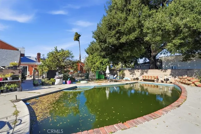 a view of a yard with a car parked in front of a house