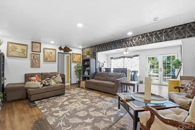 a living room with furniture and kitchen view