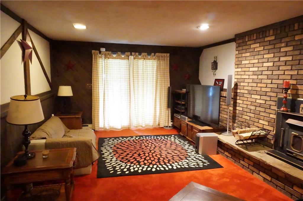289 Hellein School Road Acme, PA 15610 - Photo 16 of 25 Game Room/Family Room with access to back yard and deck. Notice how half wall of brick continues to corner.