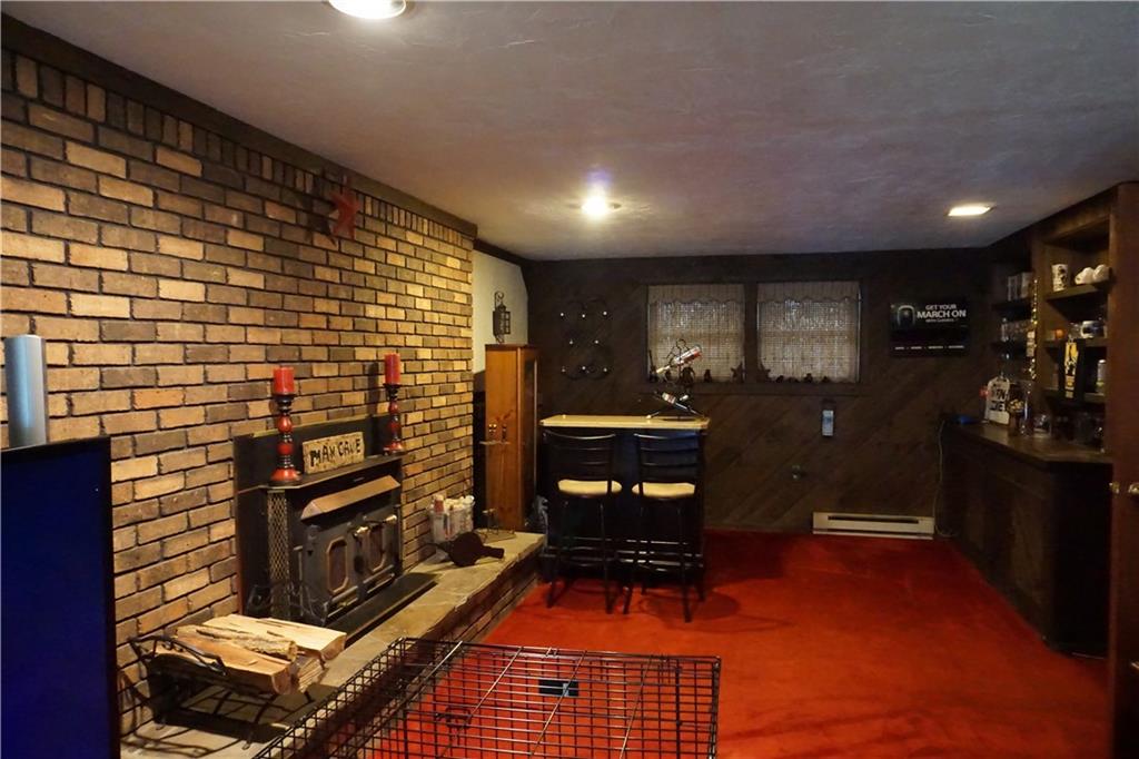 289 Hellein School Road Acme, PA 15610 - Photo 18 of 25 Game Room / Family Room with wood burning fireplace. Built in cabinets on Right.