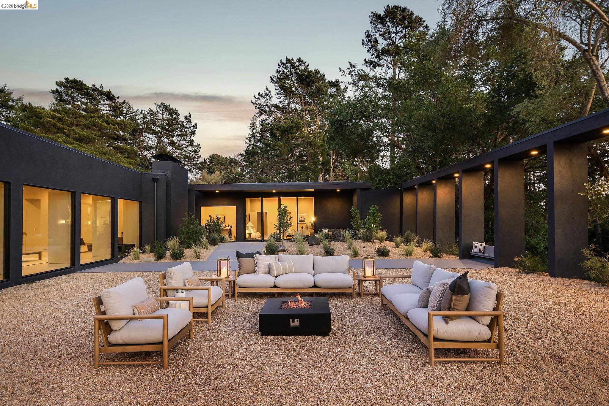 5645 Bacon Road Oakland, CA 94619 - Photo 2 of 60 Back of property featuring a patio area, an outdoor living space with a fire pit, and stucco siding