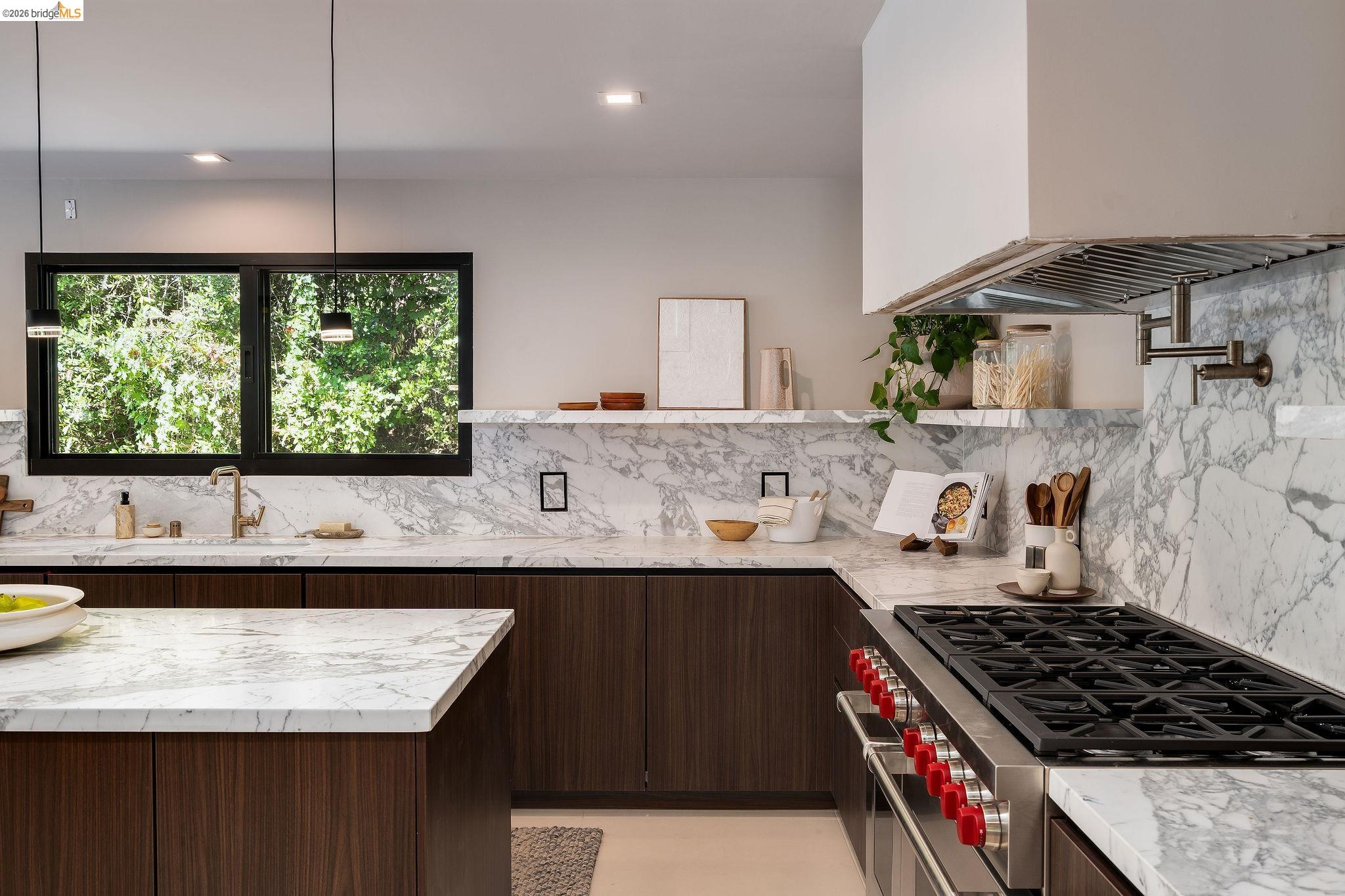 5645 Bacon Road Oakland, CA 94619 - Photo 27 of 60 Kitchen featuring high end stove, light stone counters, dark wood finish cabinetry, and modern cabinets