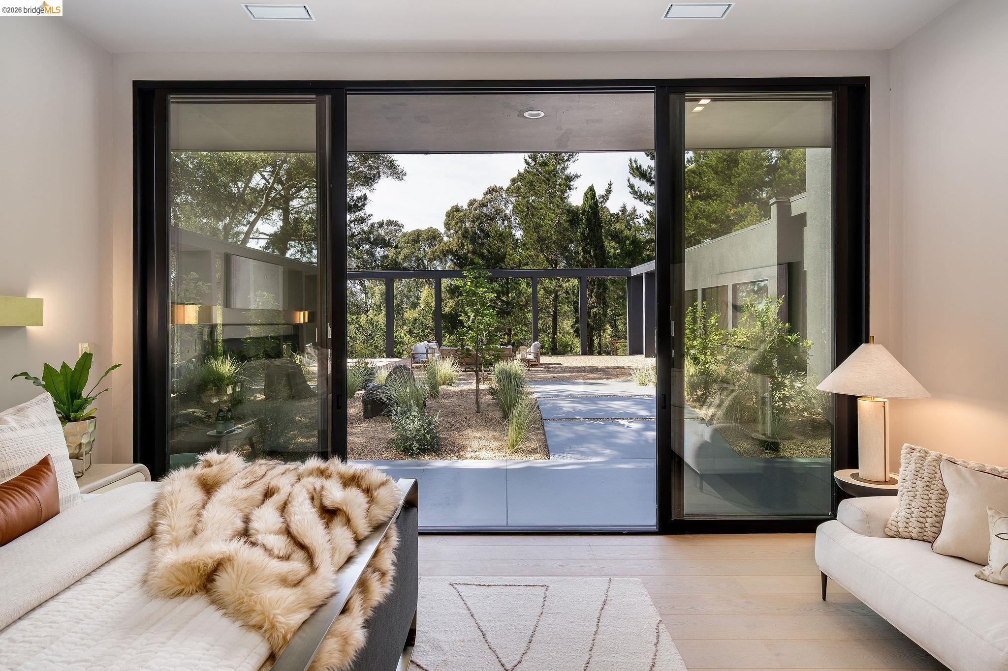 5645 Bacon Road Oakland, CA 94619 - Photo 31 of 60 Bedroom with light wood finished floors, access to exterior, and multiple windows