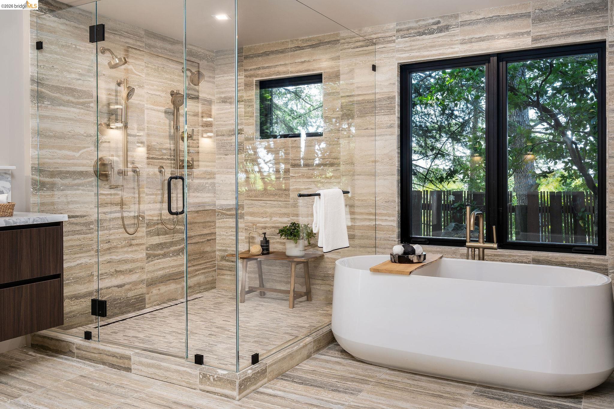 5645 Bacon Road Oakland, CA 94619 - Photo 34 of 60 Full bath with a freestanding tub, a stall shower, vanity, and tile walls