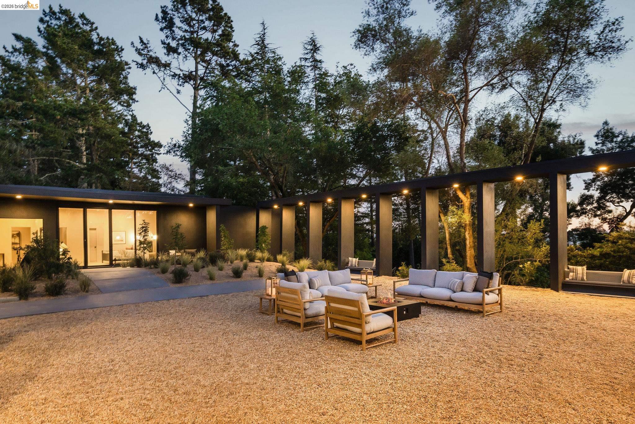5645 Bacon Road Oakland, CA 94619 - Photo 45 of 60 Back of house at dusk featuring an outdoor hangout area, stucco siding, and a patio