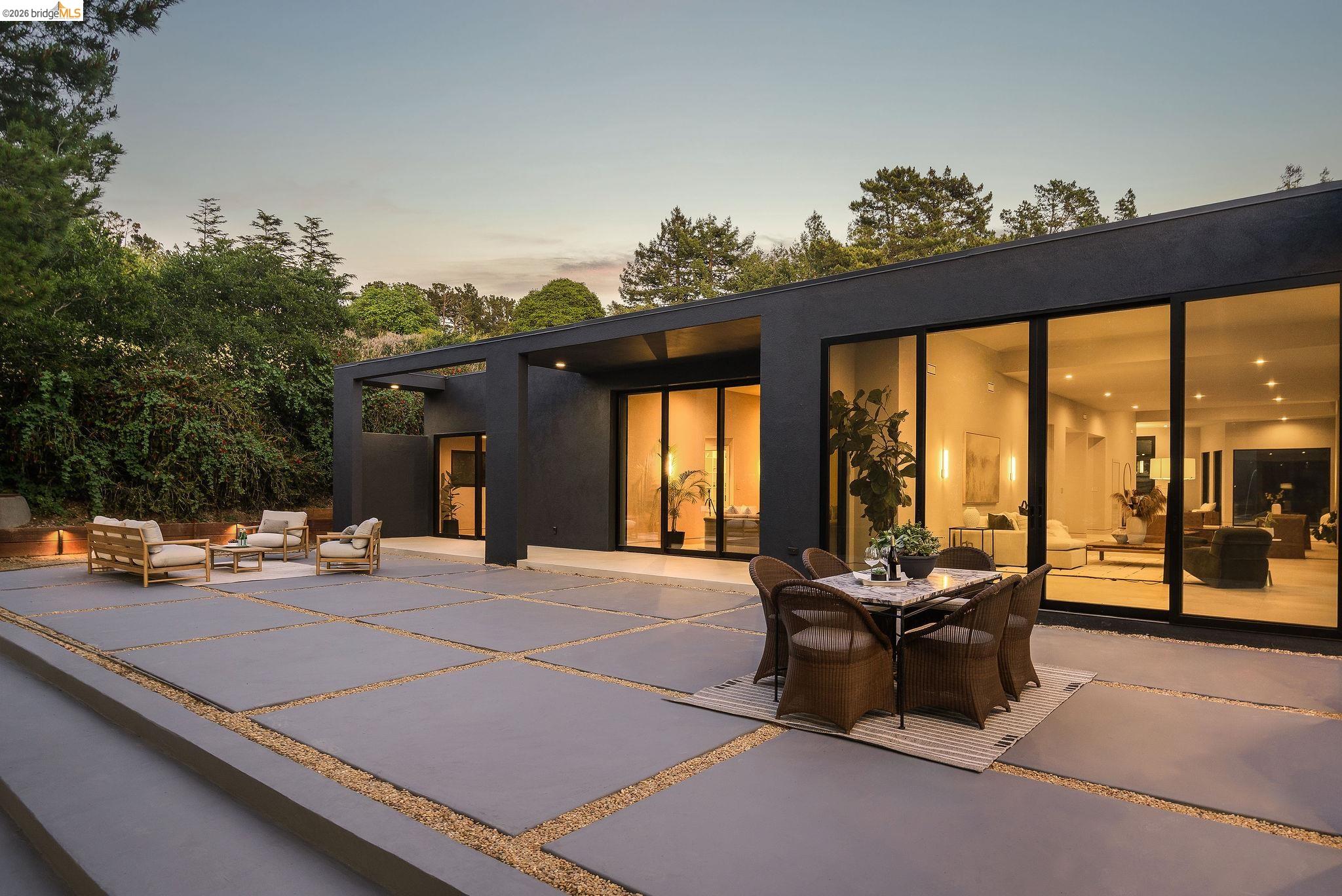 5645 Bacon Road Oakland, CA 94619 - Photo 46 of 60 Back of property at dusk featuring a patio area, outdoor lounge area, and stucco siding