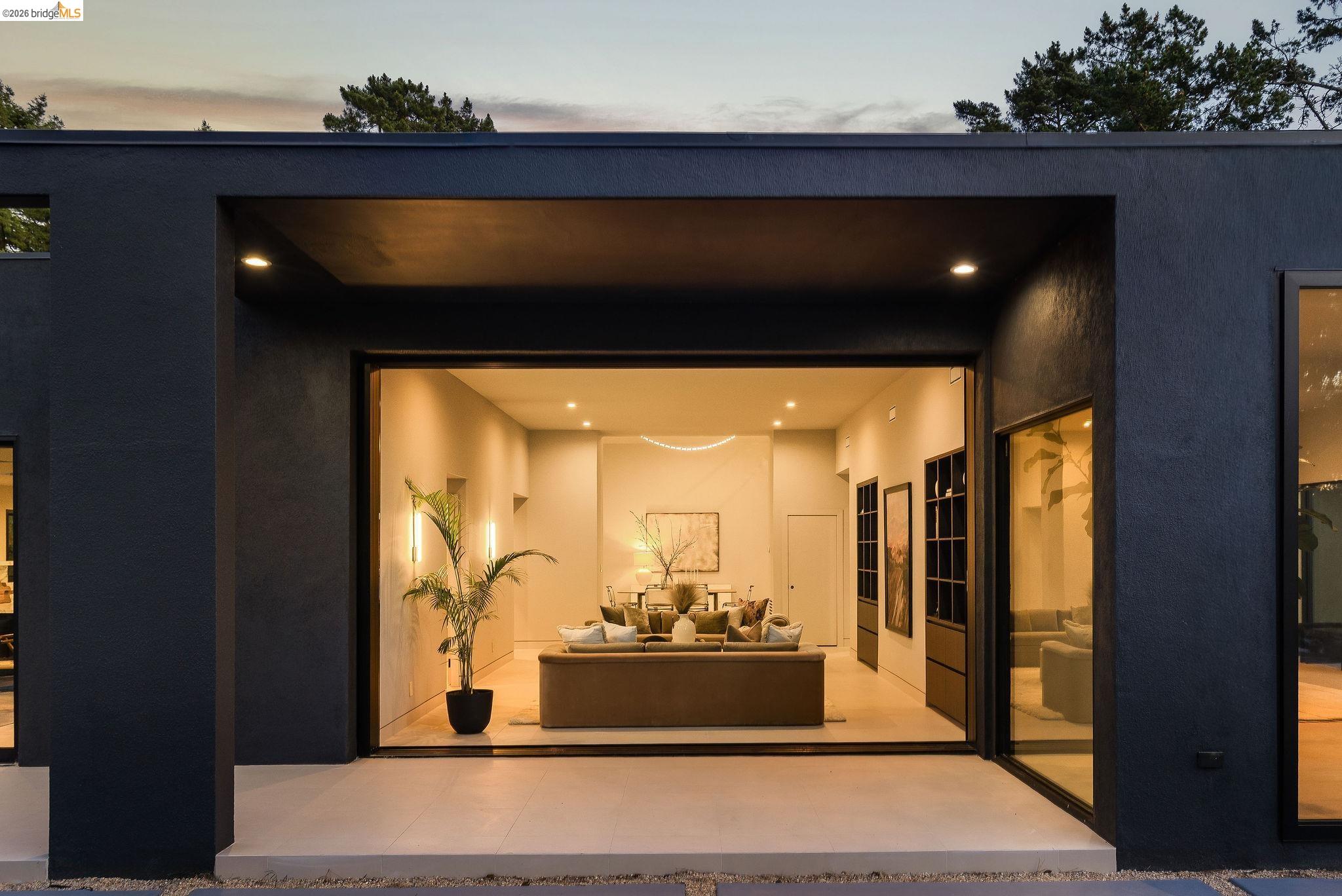 5645 Bacon Road Oakland, CA 94619 - Photo 6 of 60 Exterior entry at dusk featuring stucco siding and a patio