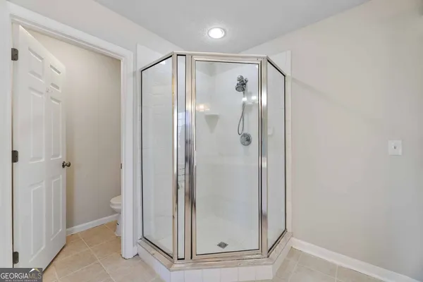 a bathroom with a glass shower door