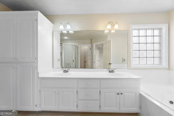 a bathroom with a sink vanity and mirror