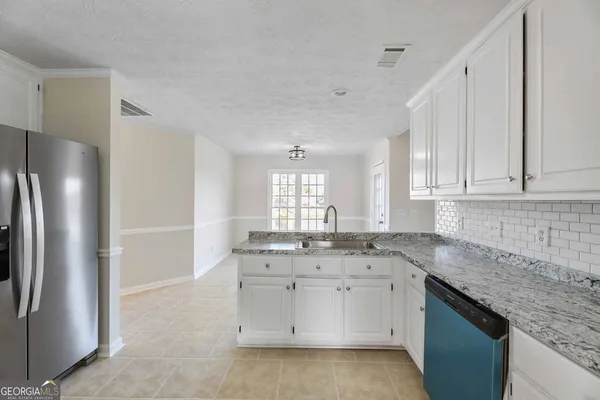 a kitchen with a sink stove and refrigerator