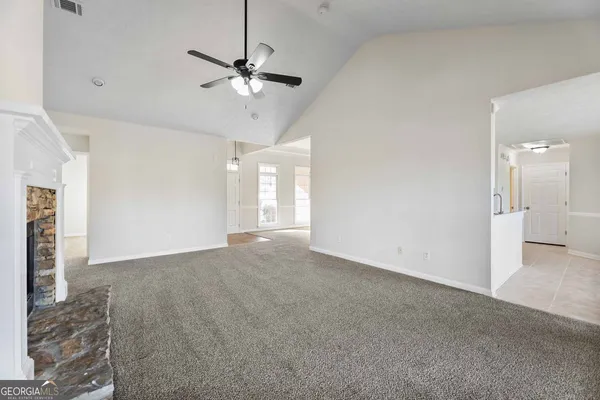 a view of a livingroom with a ceiling fan and window