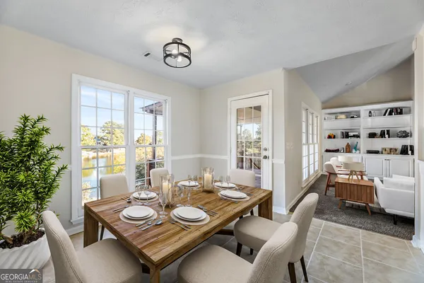 a dining room with furniture and wooden floor