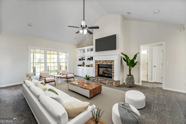 a living room with furniture a fireplace and a flat screen tv