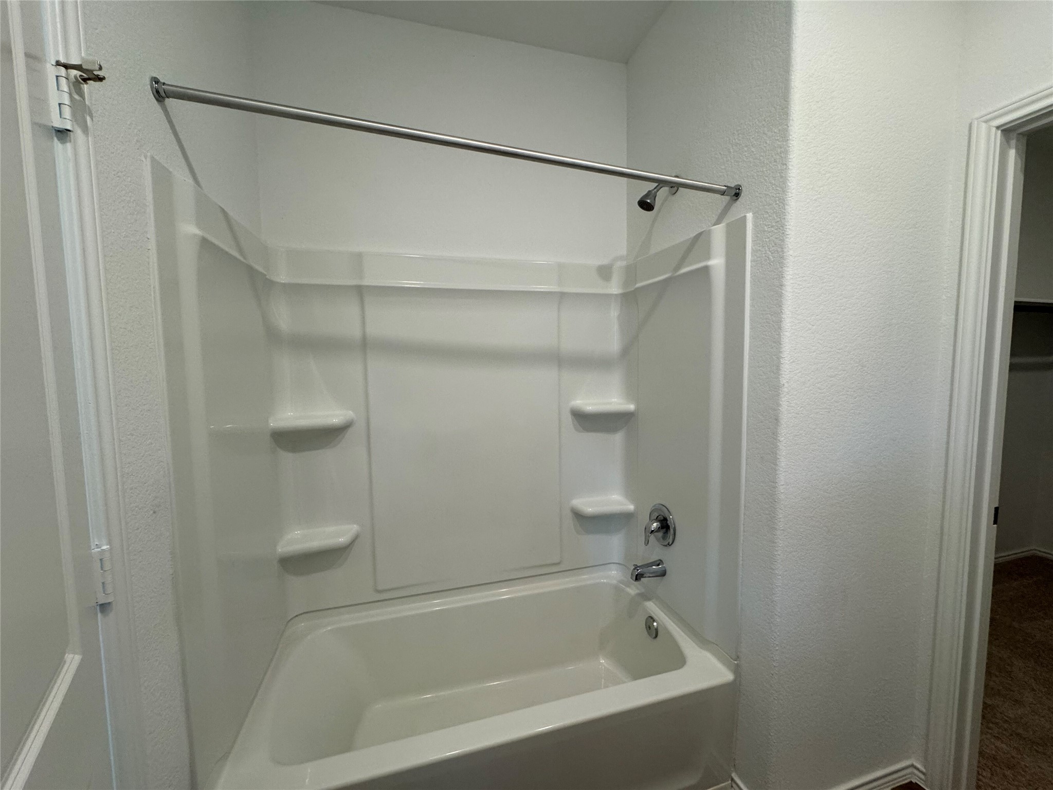 203 Tufted Duck Path Kyle, TX 78640 - Photo 12 of 19 Full bath featuring a textured wall and washtub / shower combination