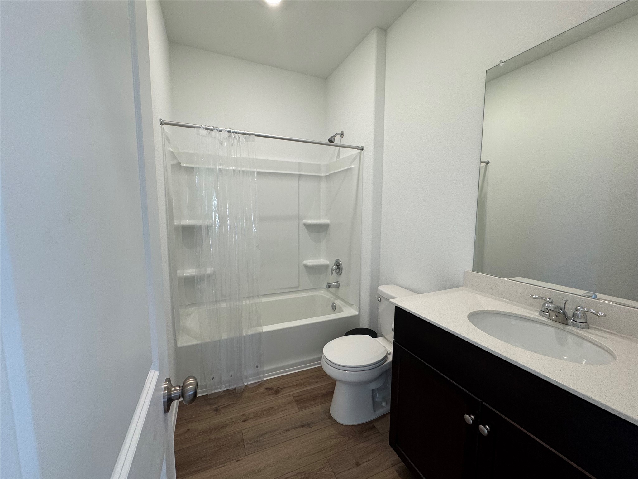 203 Tufted Duck Path Kyle, TX 78640 - Photo 14 of 19 Bathroom featuring vanity, dark wood-style flooring, and shower / bathtub combination