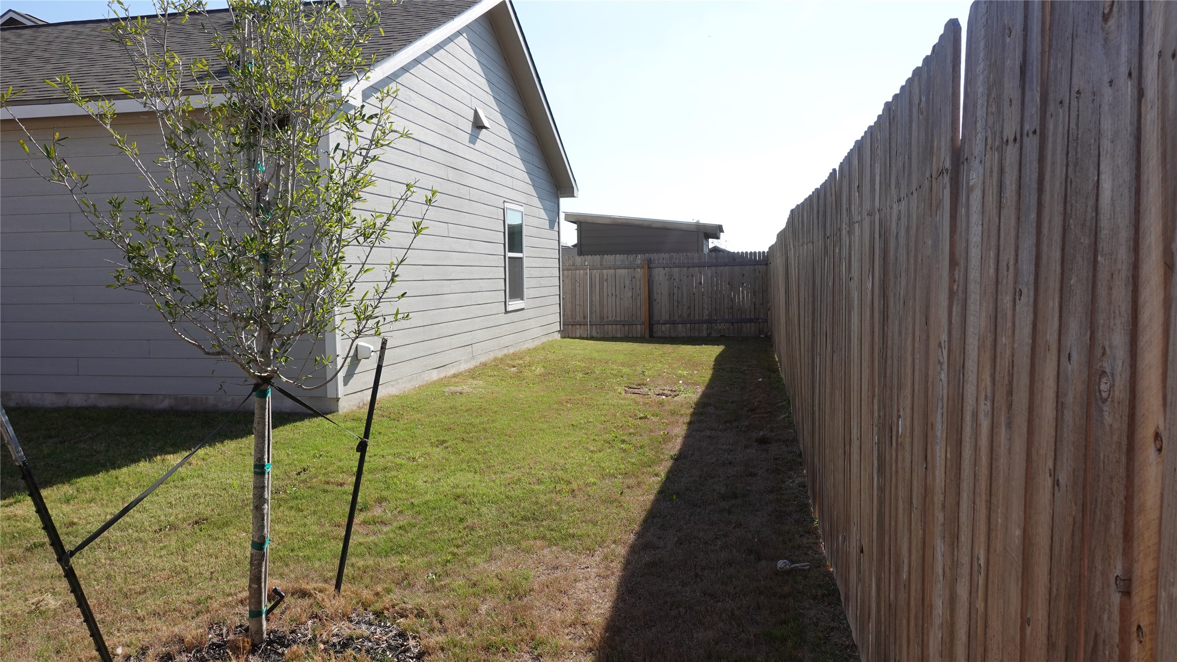203 Tufted Duck Path Kyle, TX 78640 - Photo 16 of 19 View of property exterior featuring a fenced backyard