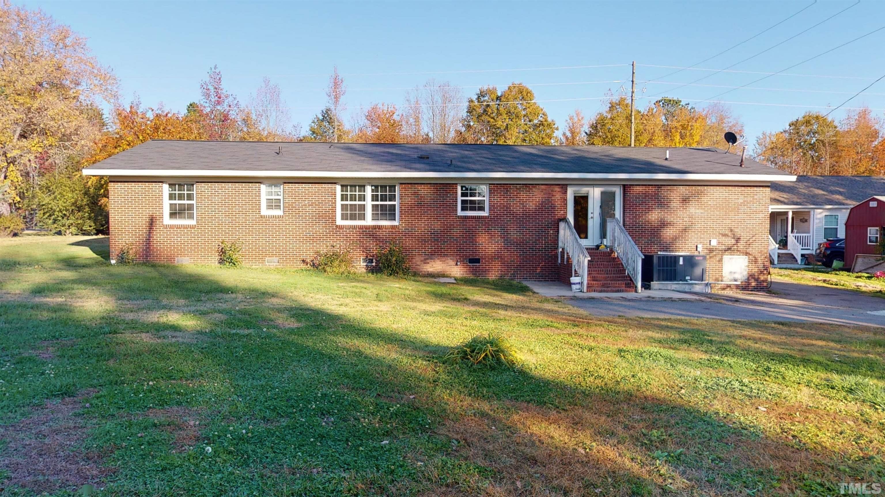 1306 Old Durham Road Roxboro, NC 27573 - Photo 1 of 28 a view of a house with backyard and swimming pool