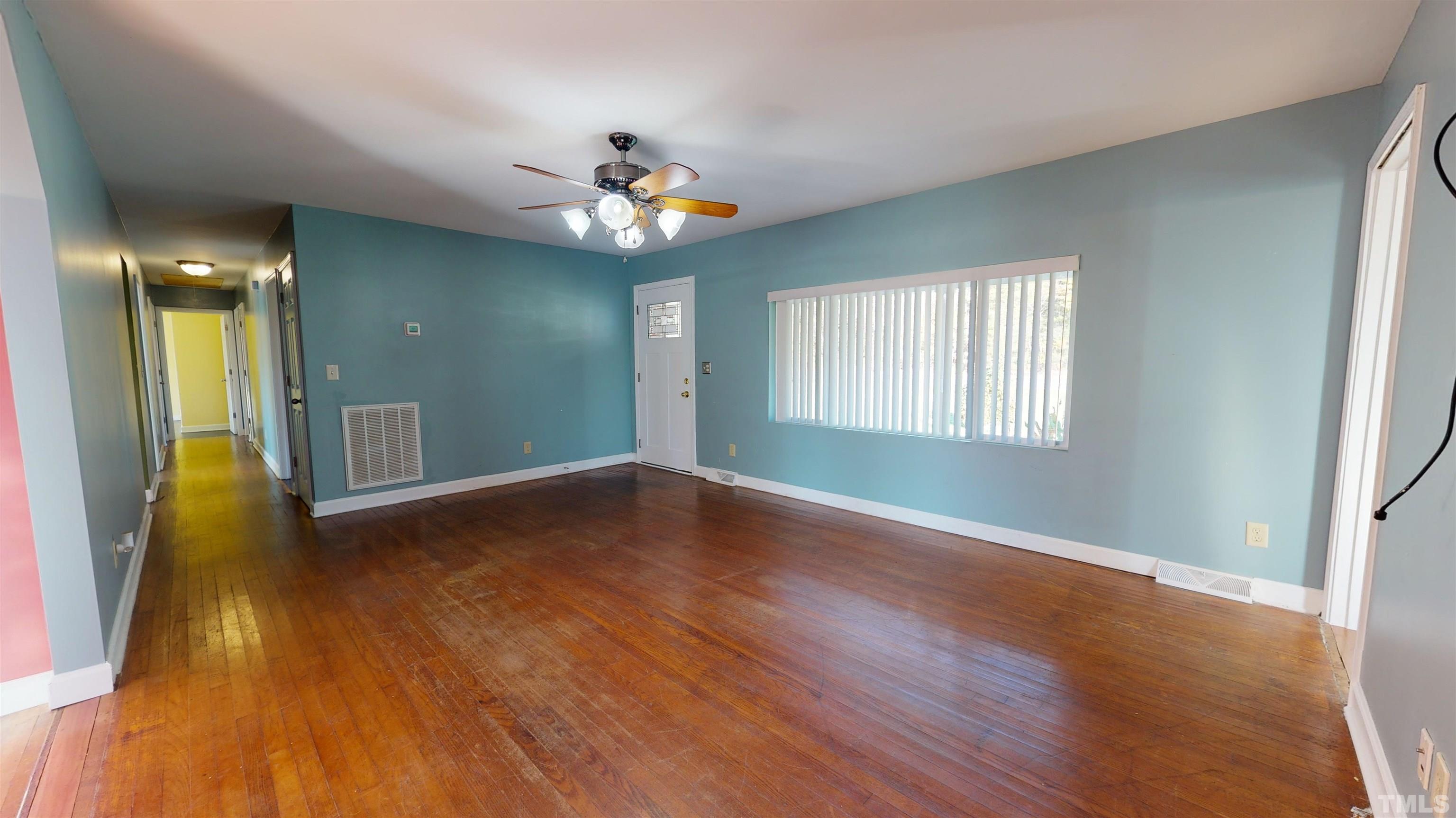1306 Old Durham Road Roxboro, NC 27573 - Photo 12 of 28 a view of empty room with wooden floor and fan